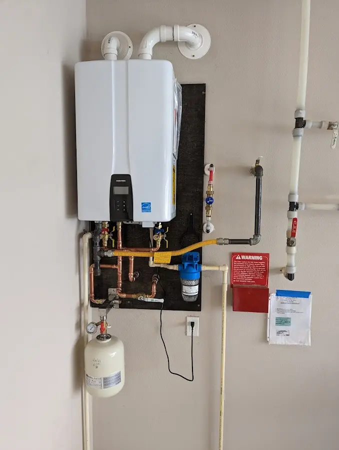 Professional plumber installing copper piping in a Vinton home